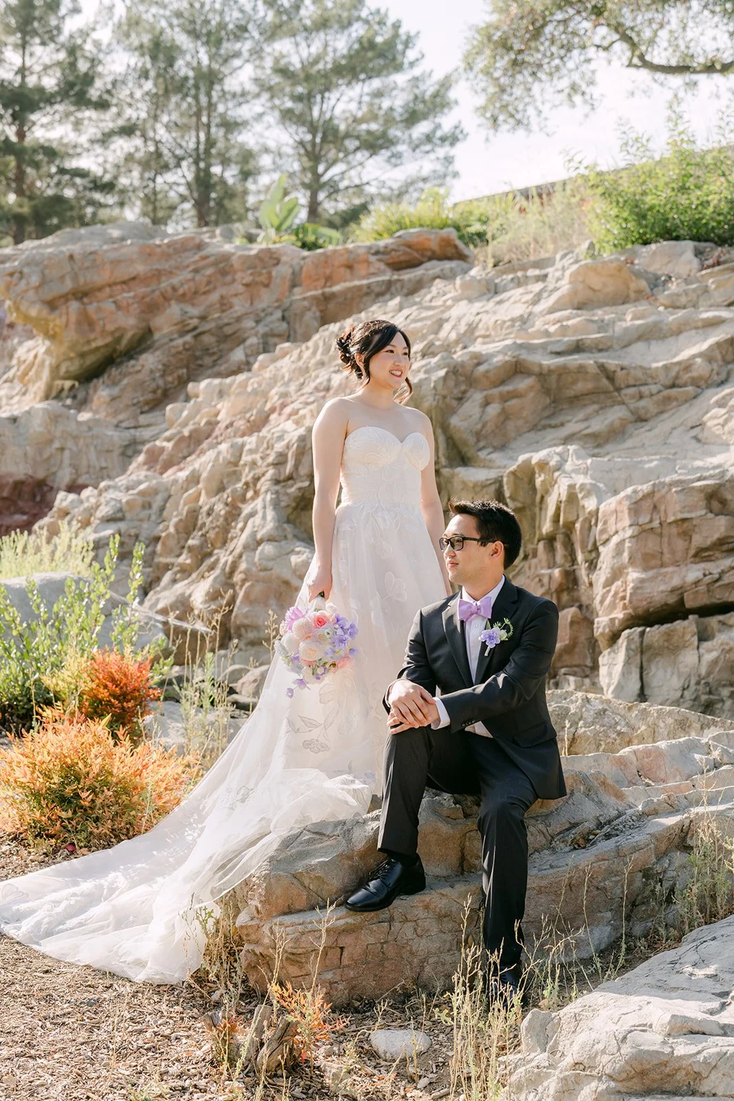 Patrick seated on the rocks beside Mary