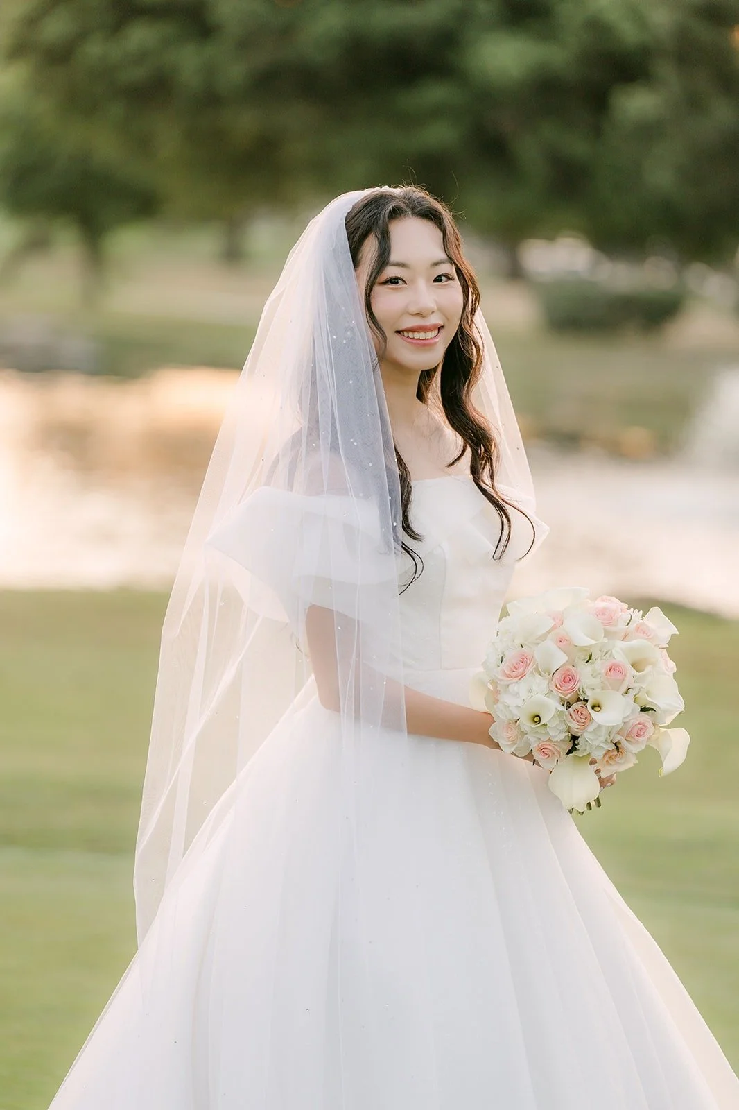 Jeannie laughing with her bouquet in the warm sunset light
