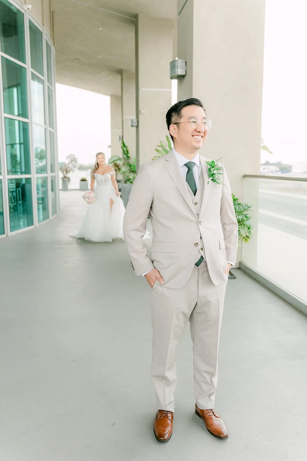 Ricky waiting on the balcony as Raine walks up behind him for their first look