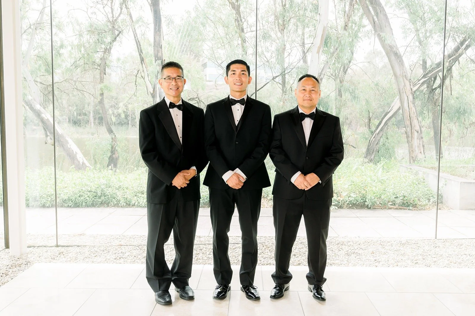 Steven with his groomsmen in black tuxedos