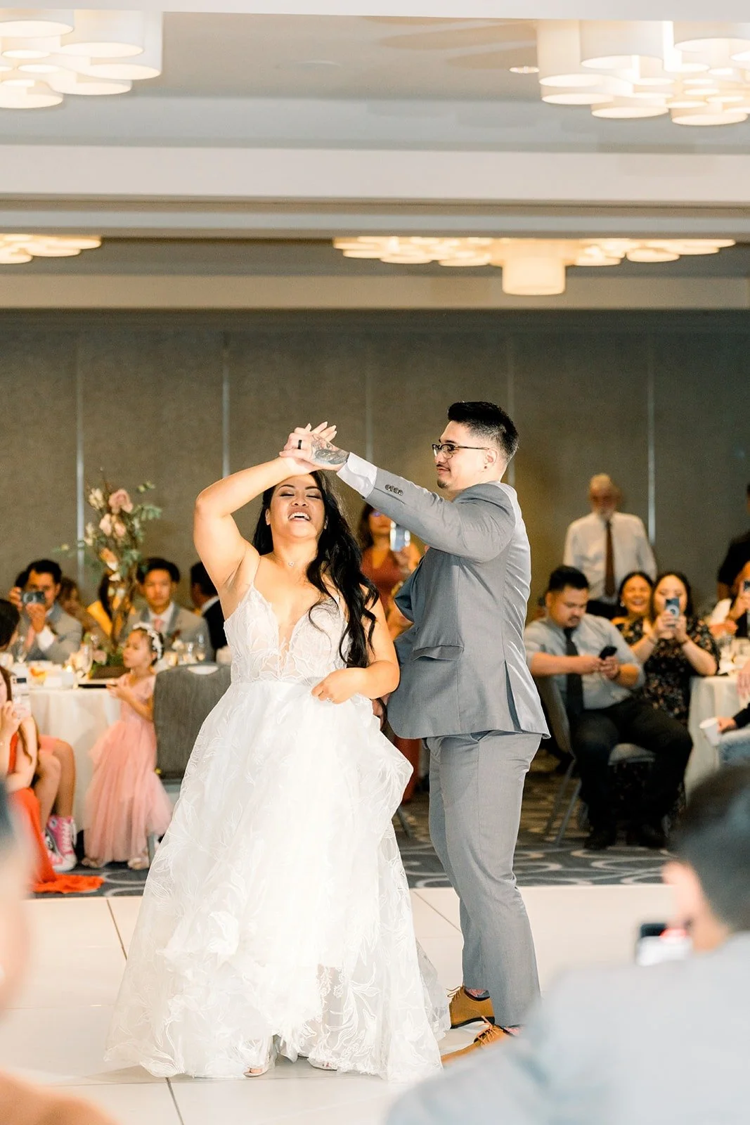Mikey twirls Betsy under the chandeliers