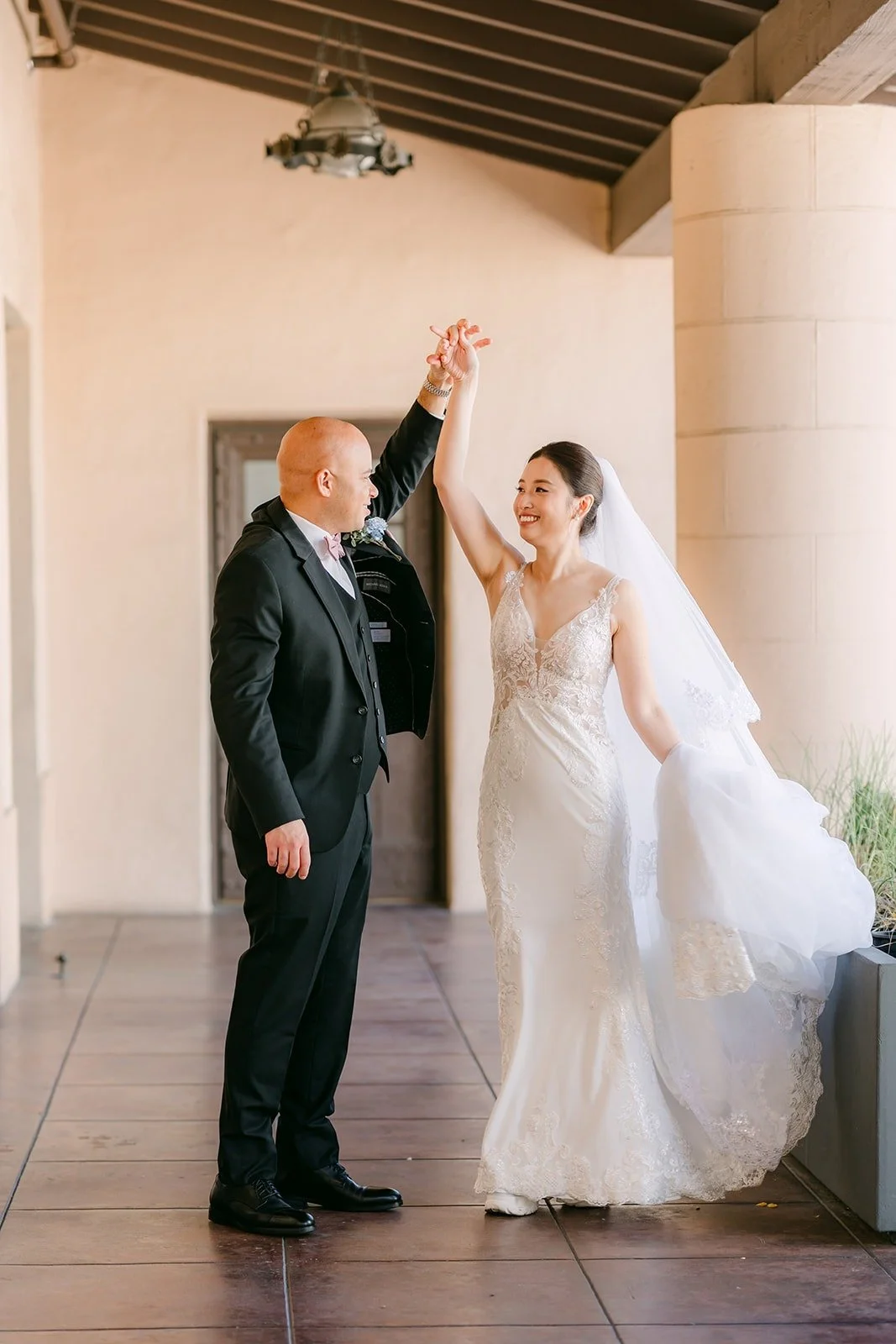 Brandon twirls Elisa in the walkway