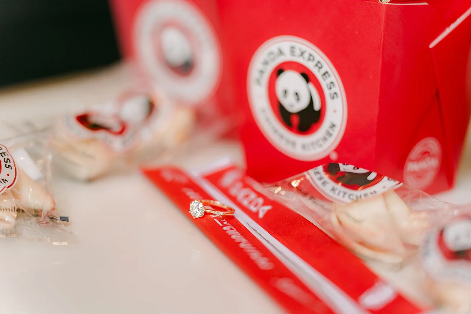 Detail of Panda Express takeout boxes, chopsticks and fortune cookies.