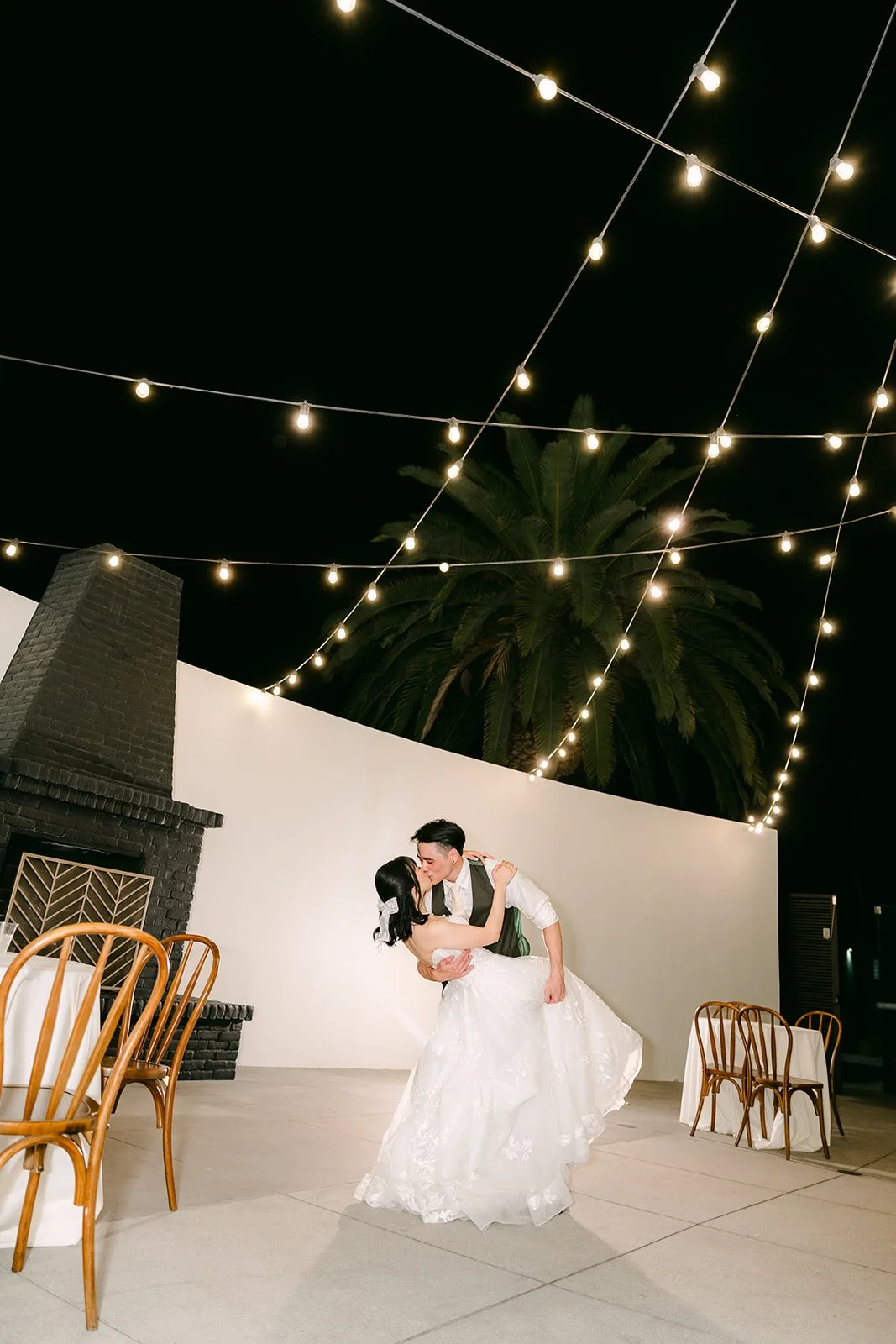 Alex twirling Vivian under the string lights, photographed by One and Only Production