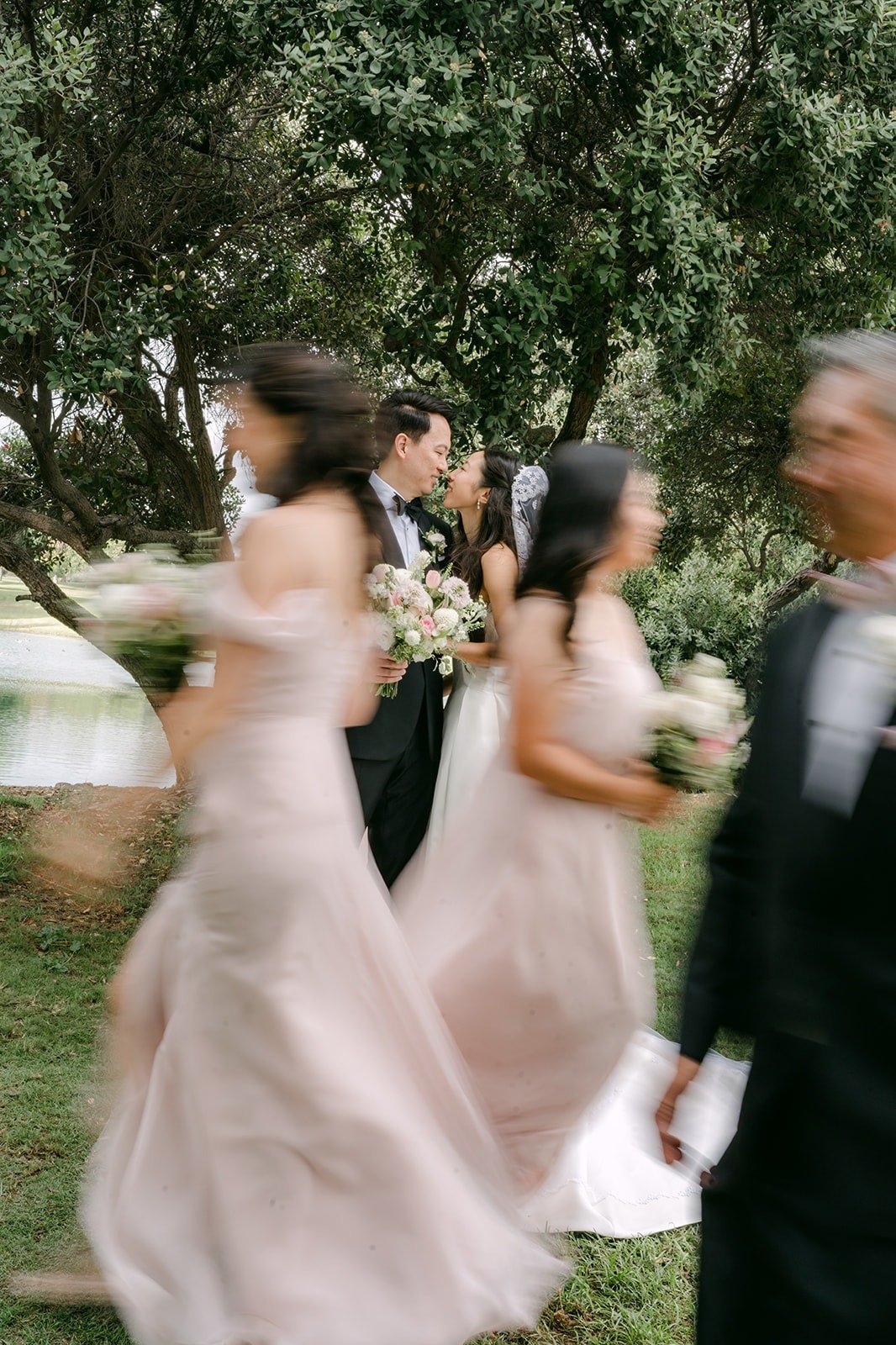 Bridesmaids laughing as they run across the lawn