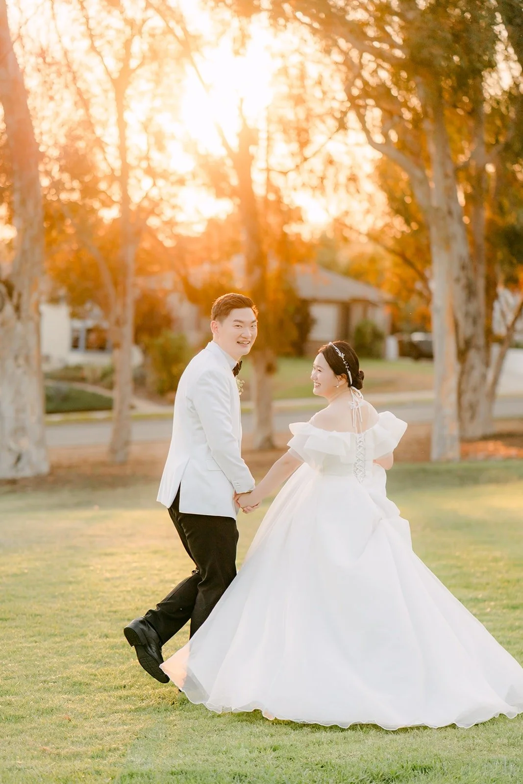 Amy and Sam dancing on the lawn in golden light, photographed by One and Only Production