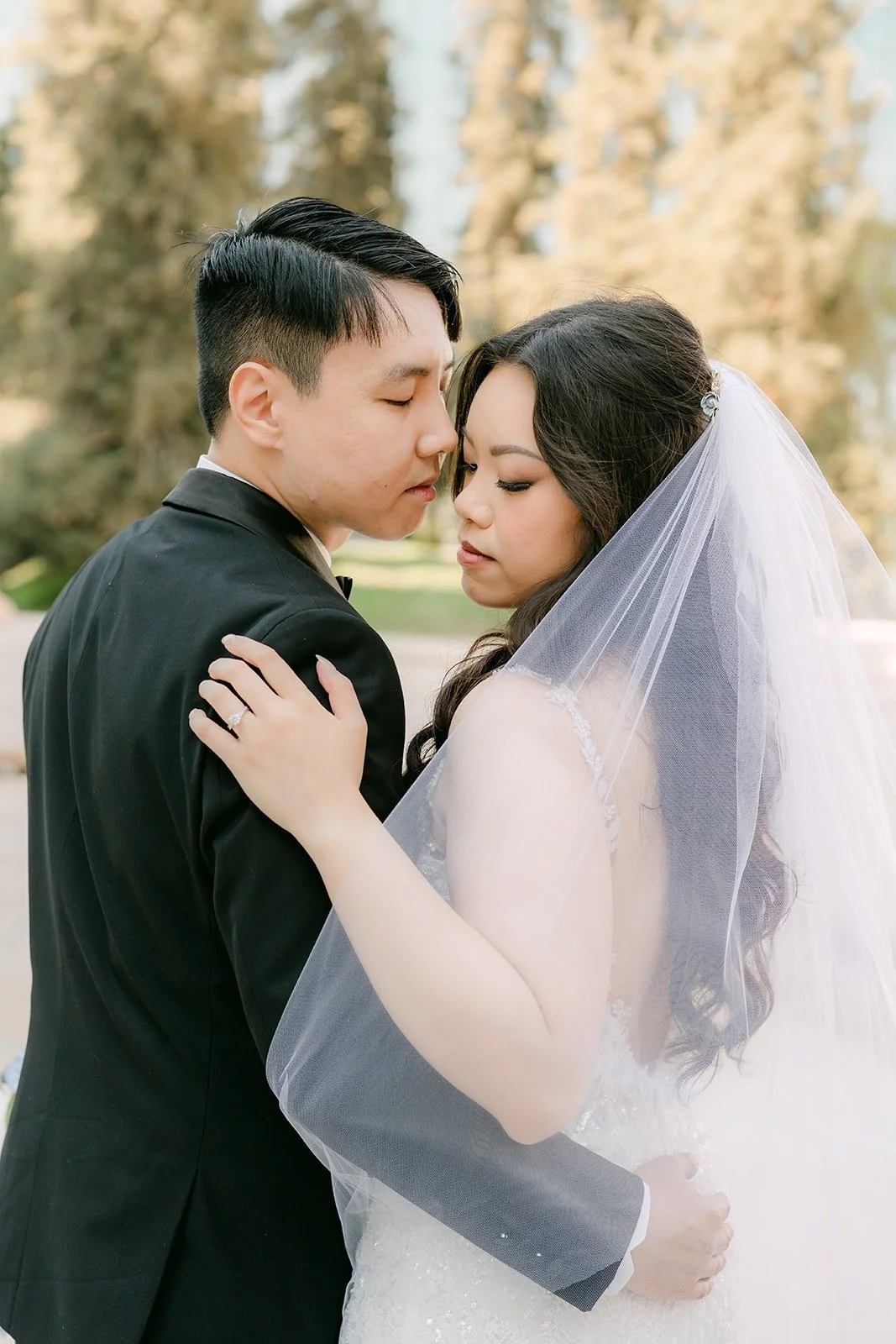 James kissing Emily's temple under her veil