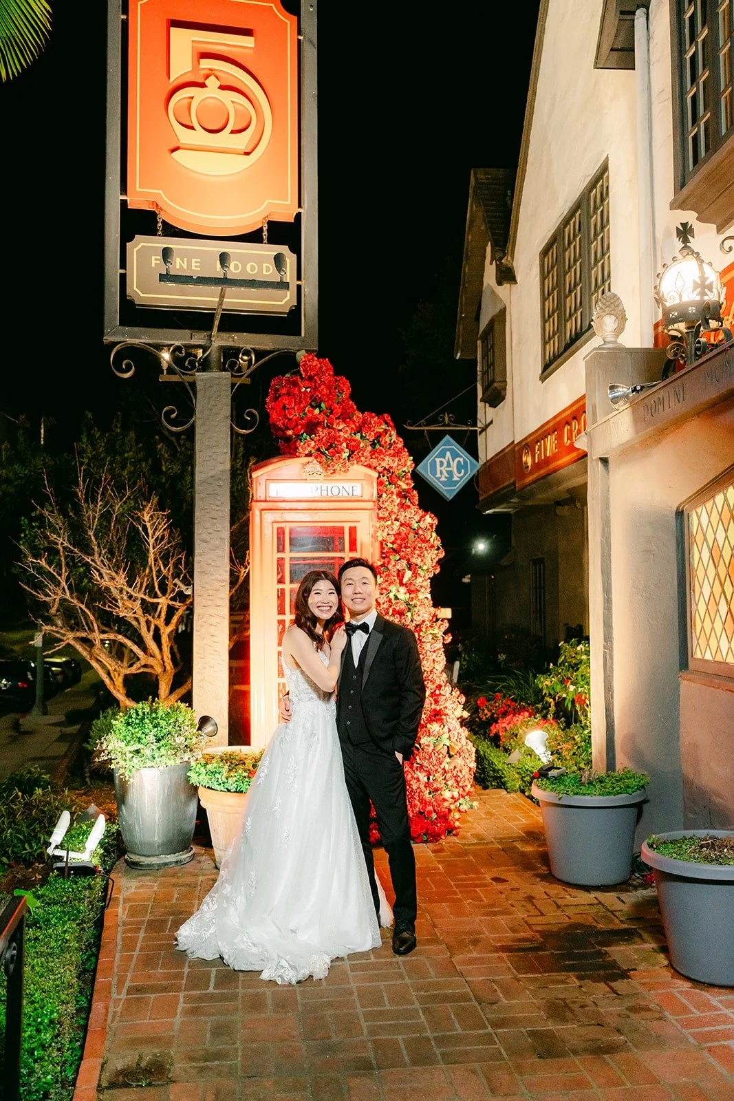 Valerie and Jason under the glowing Five Crowns sign at night