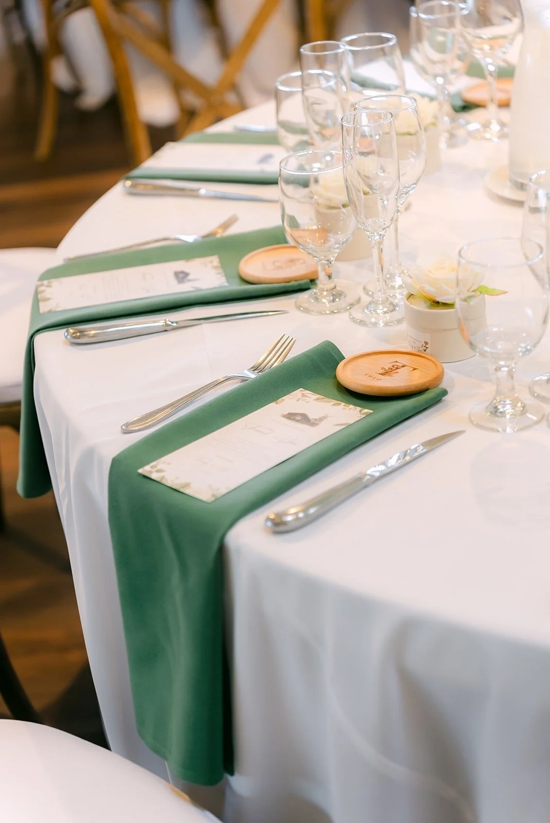 Close up of a place setting with sage green napkin