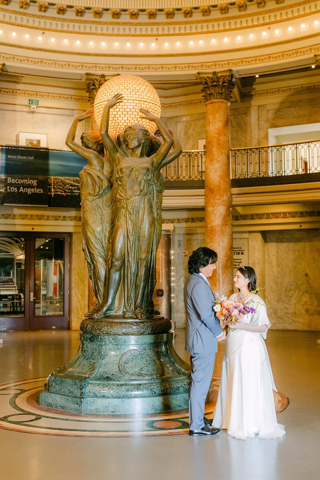 Jessie and Philip beside the bronze statue in the Rotunda
