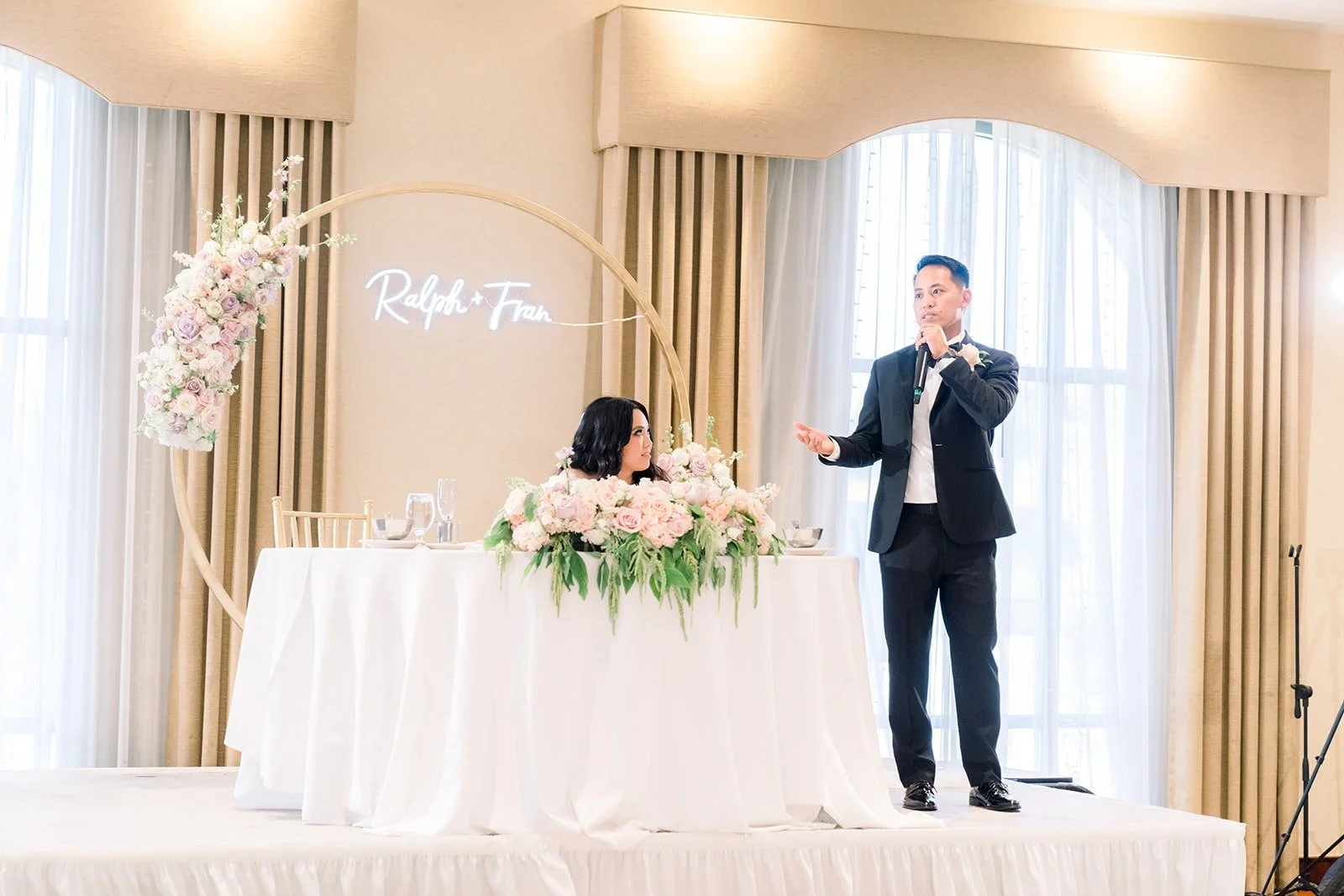 A speech delivered from beside the sweetheart table