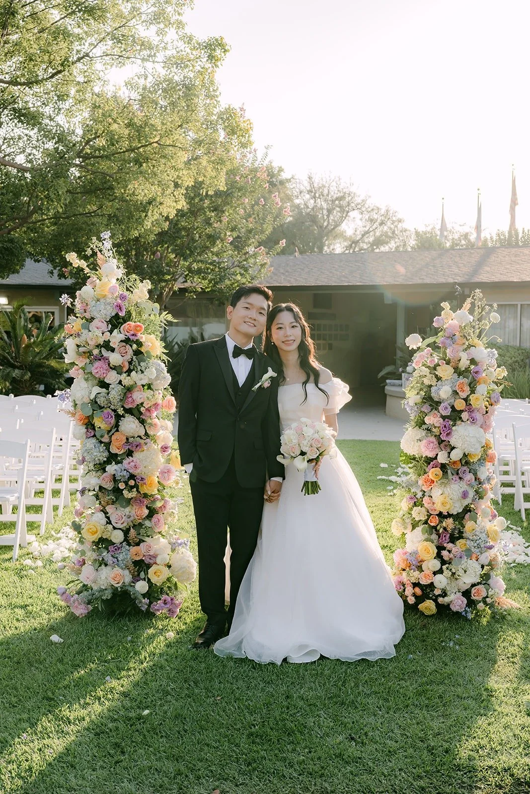 Jeannie and Eunsang between the pastel floral columns