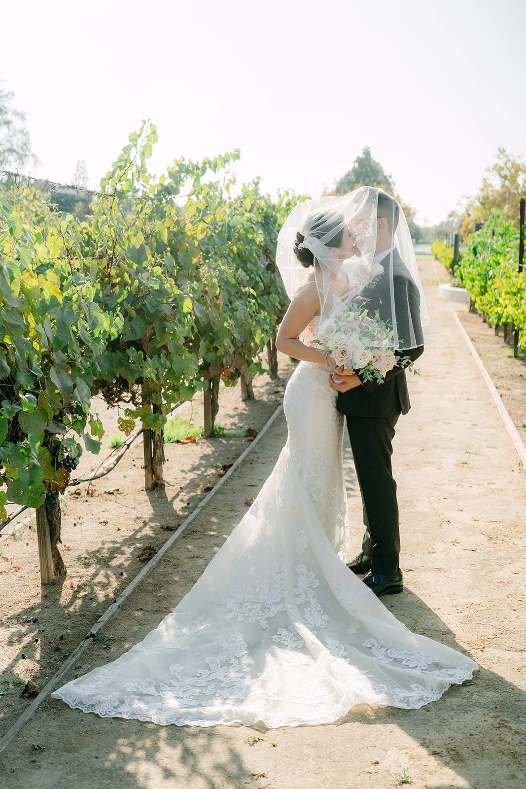 Xuemin and Alex under her veil in the vineyard