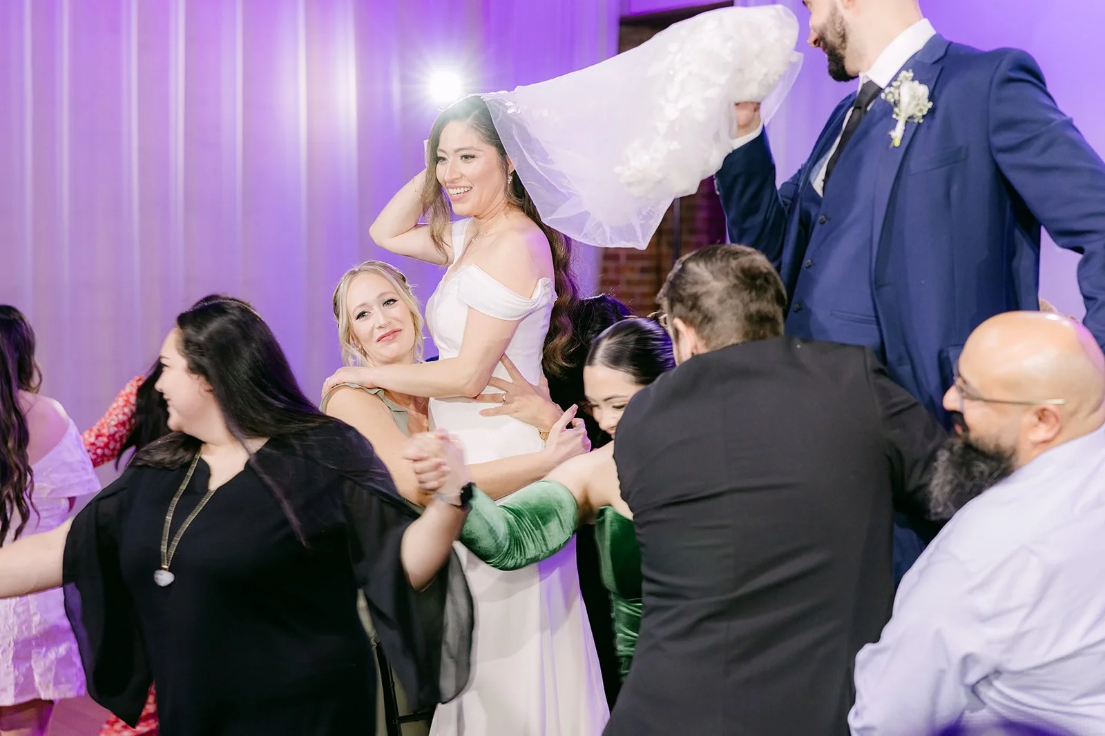 Guests gathering around Mariana during a reception game