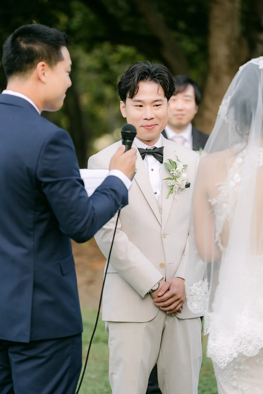 Wen reading his vows as officiant David holds the mic.