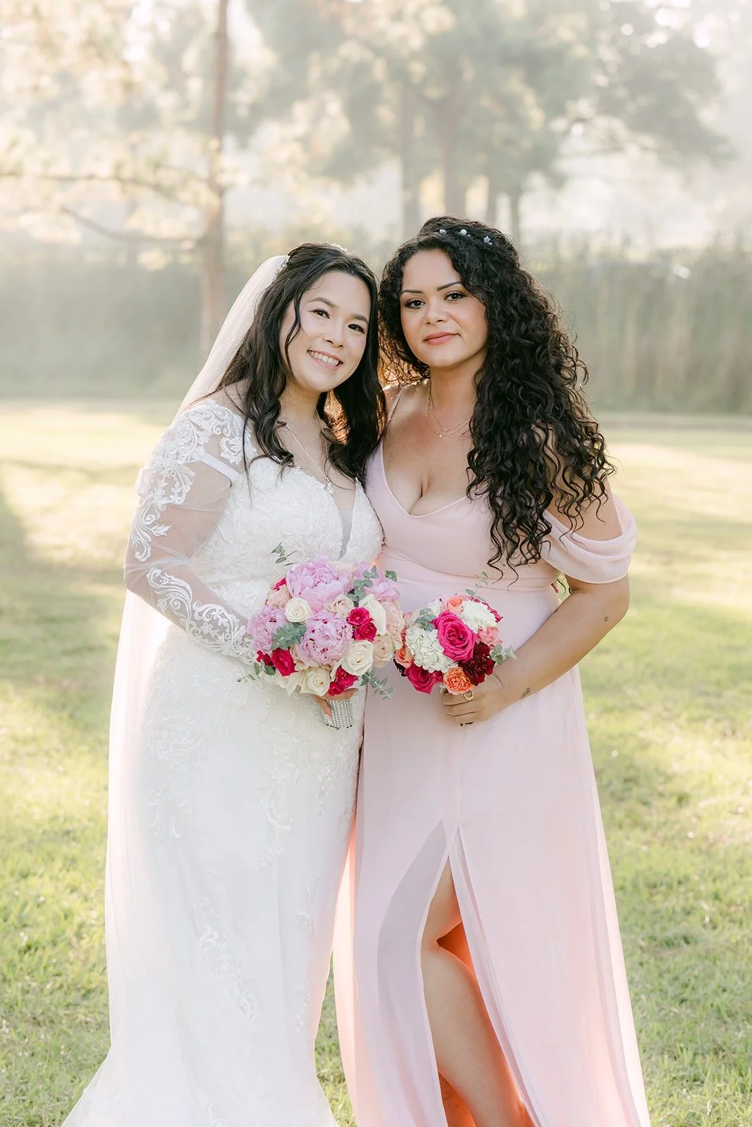 Amy and a bridesmaid hugging close in the morning light