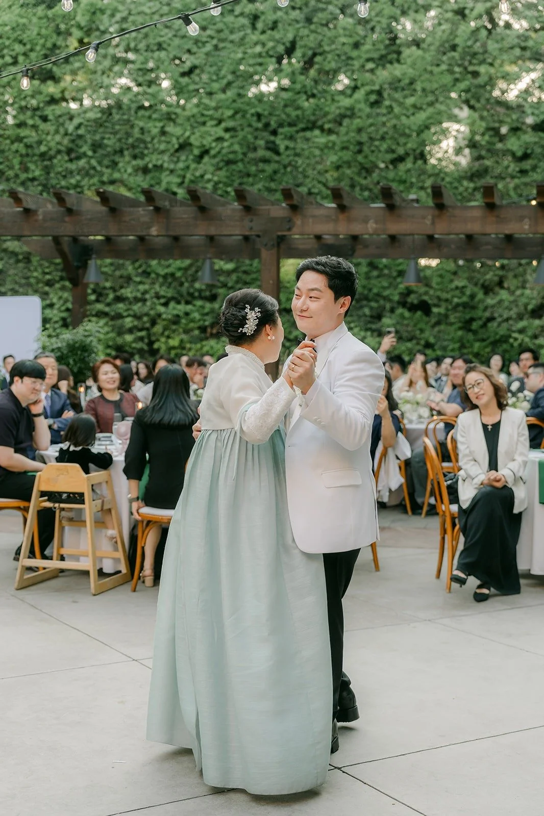Min Soo and a family member in hanbok on the dance floor, photographed by One and Only Production