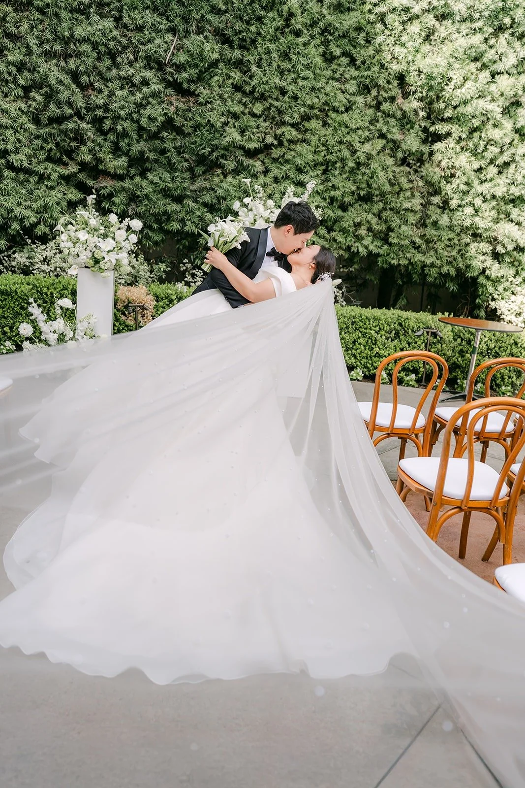 Min Soo lifting the back of Chorok's long gown and veil in the aisle