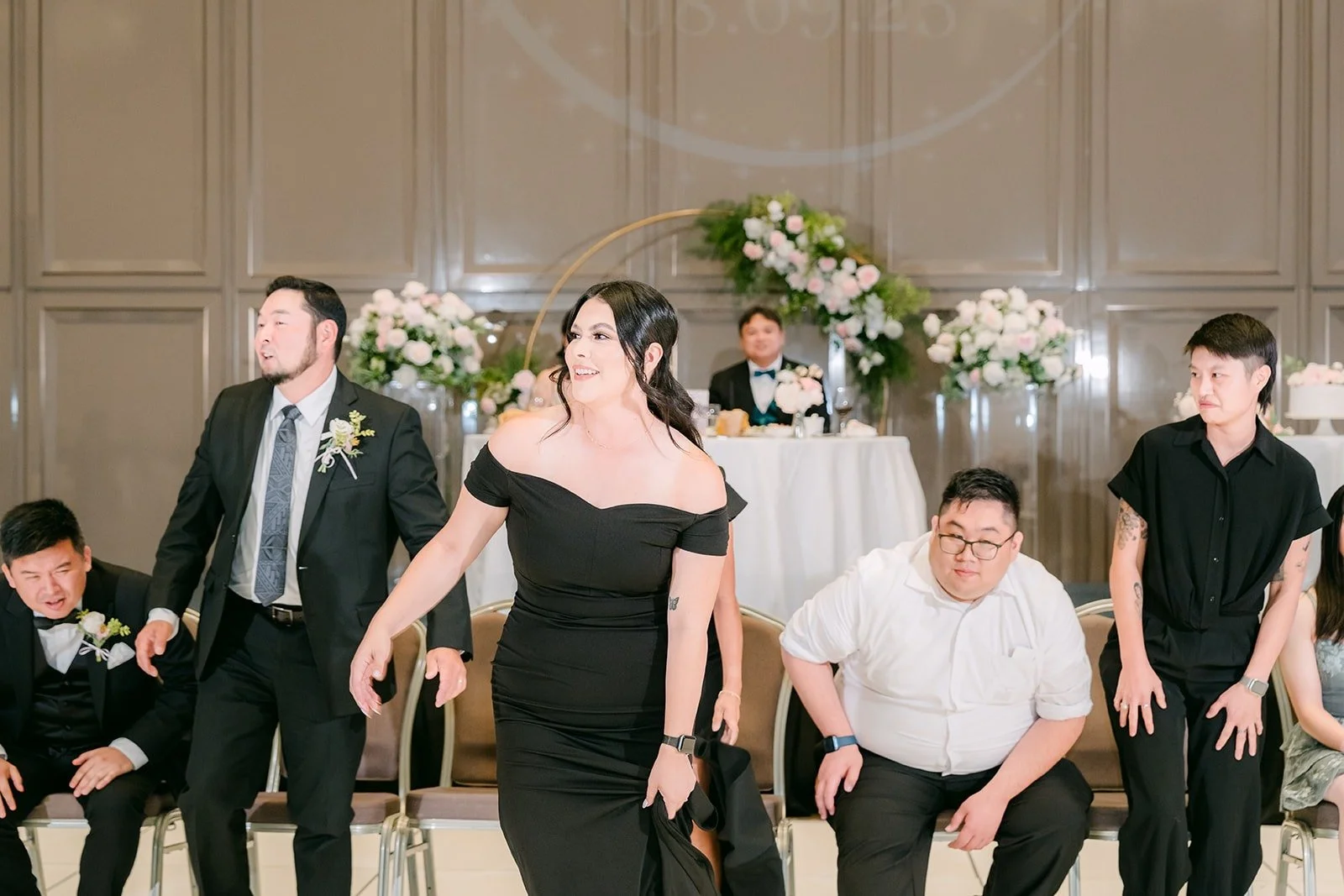 Guests and groomsmen lined up on the dance floor for a reception game