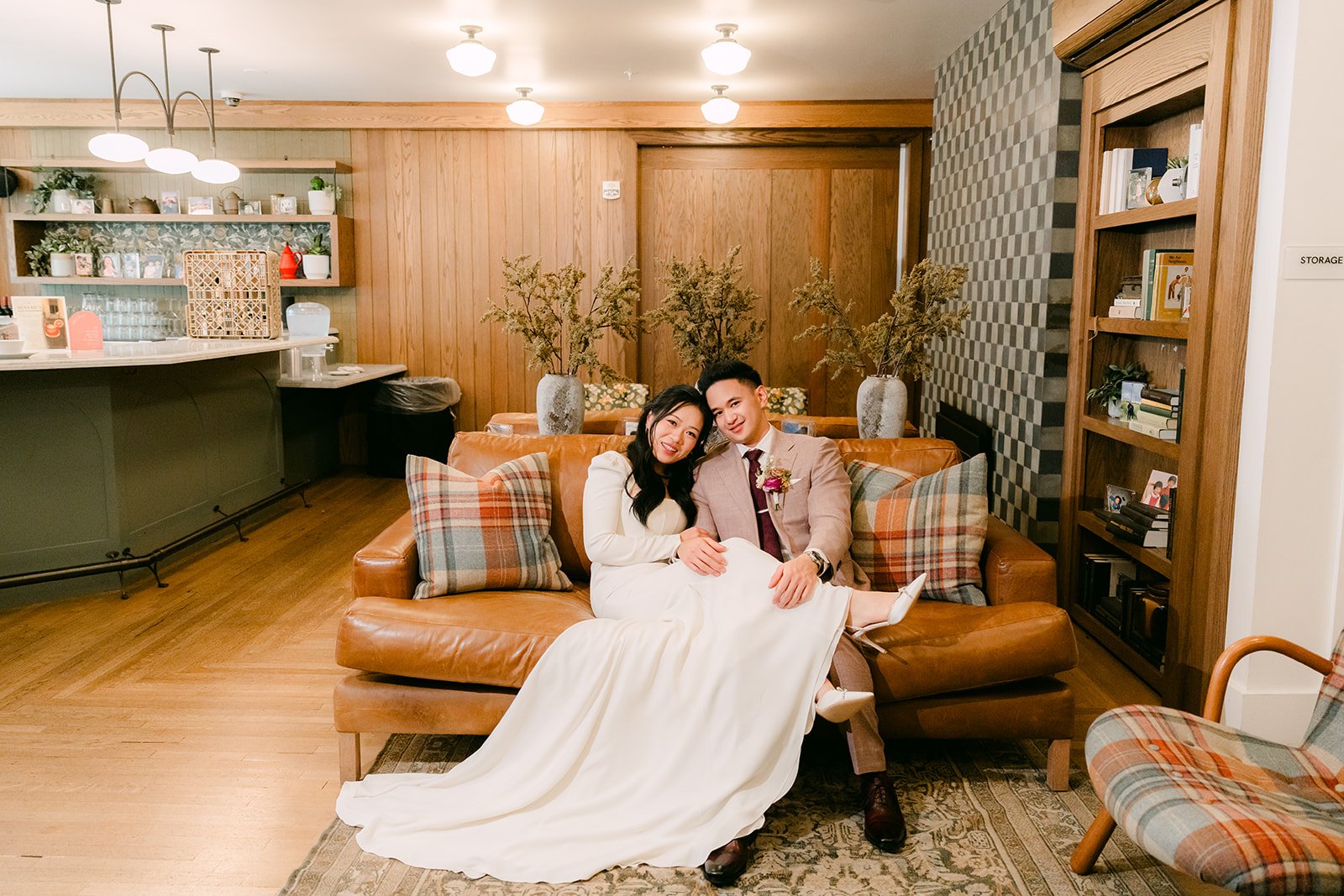 Denise and Michael relaxing on a leather sofa in The Richland's wood-paneled lounge.