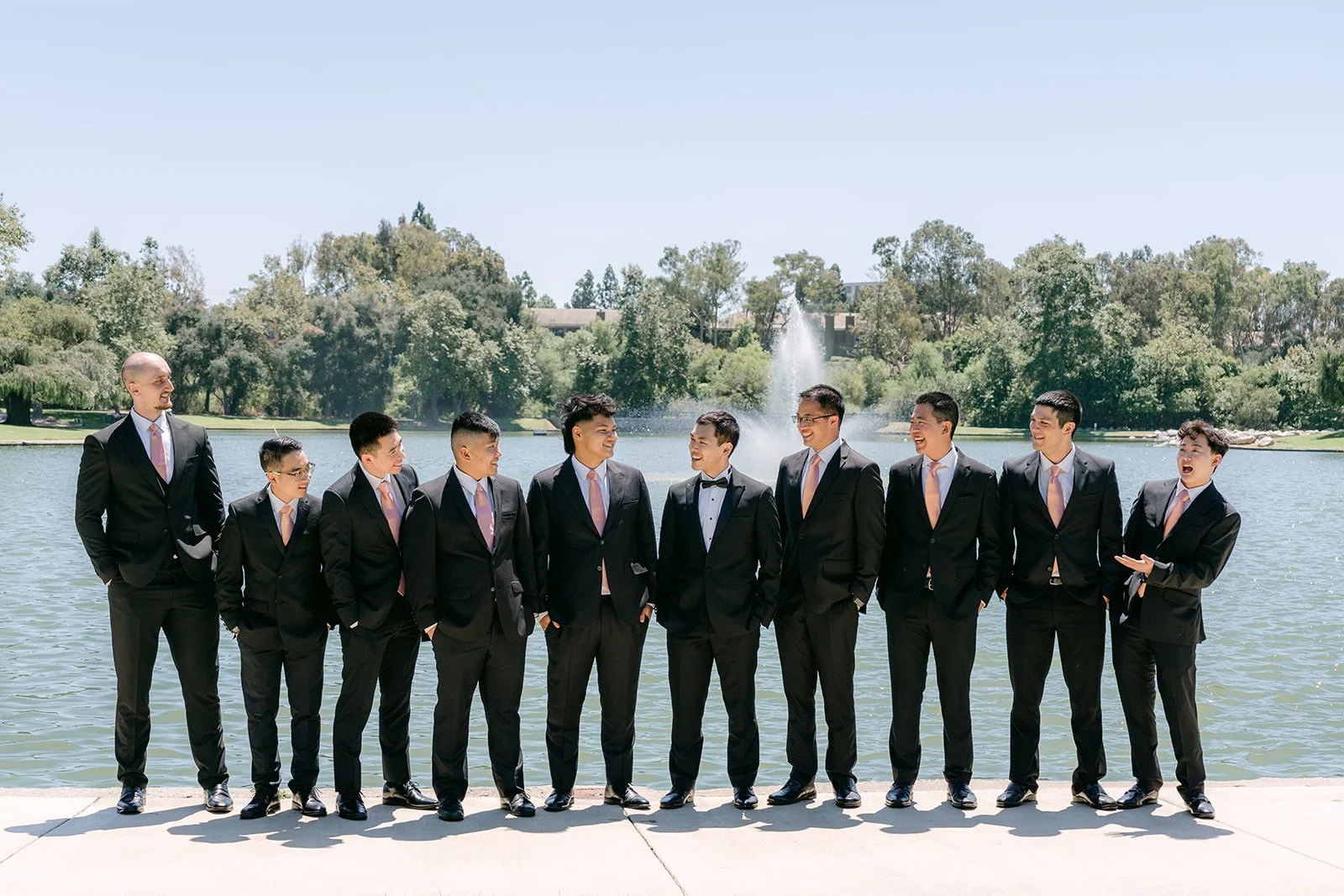 Austin and his groomsmen lined up by the lake
