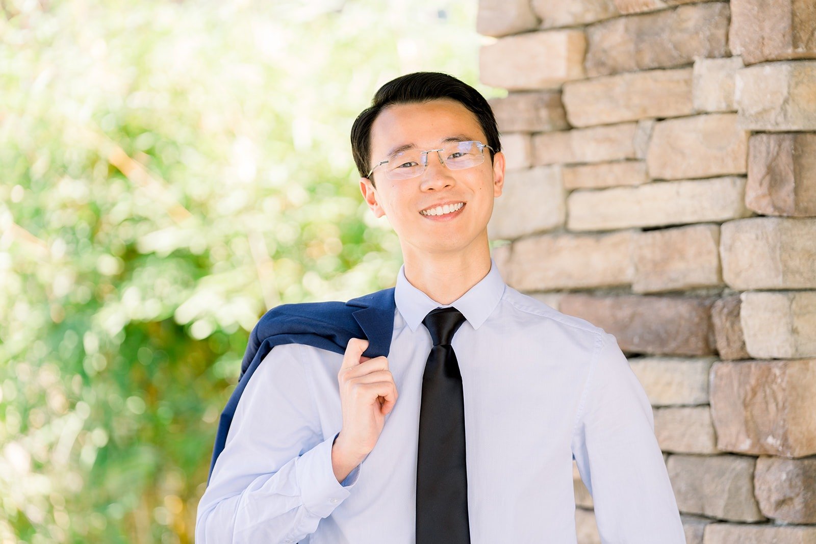 Alex adjusting his tie in the garden
