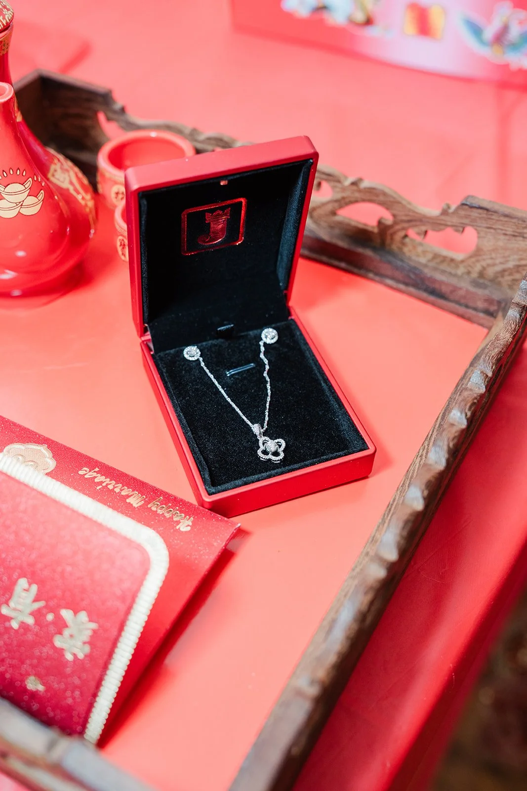 Gold jewelry in red boxes on the tea table.
