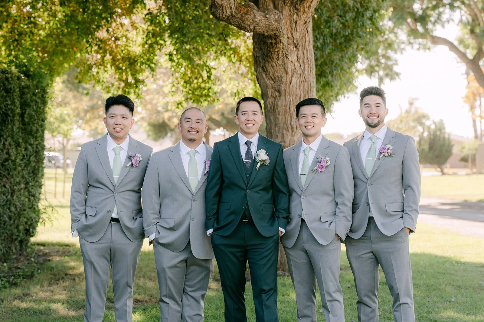 Kevin with his groomsmen in light grey suits