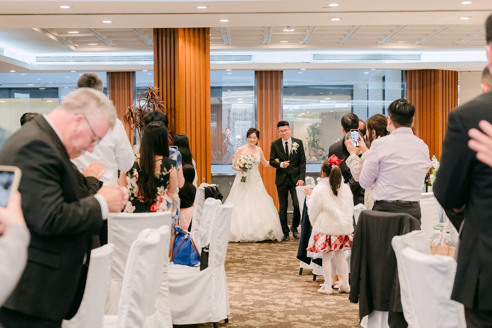 Guests cheer as the wedding party makes their entrance