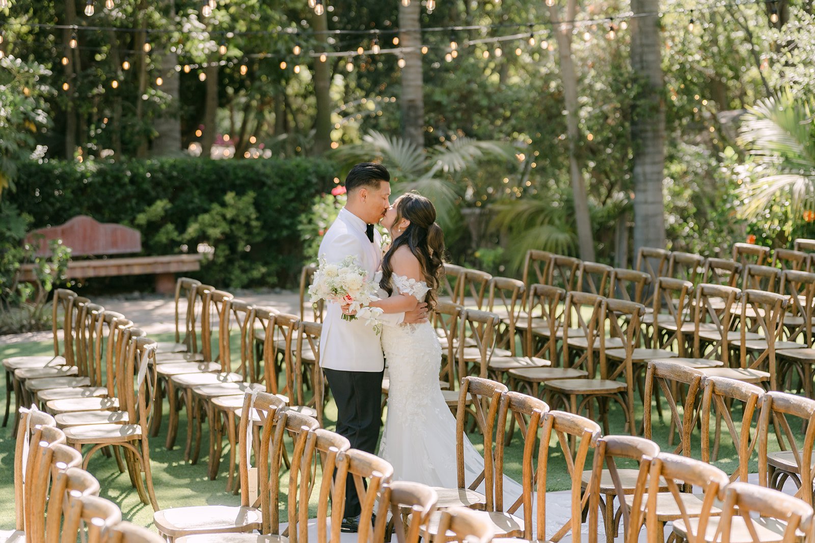 Nicole and Caryl among the wooden cross back chairs at the Eden Gardens ceremony site.