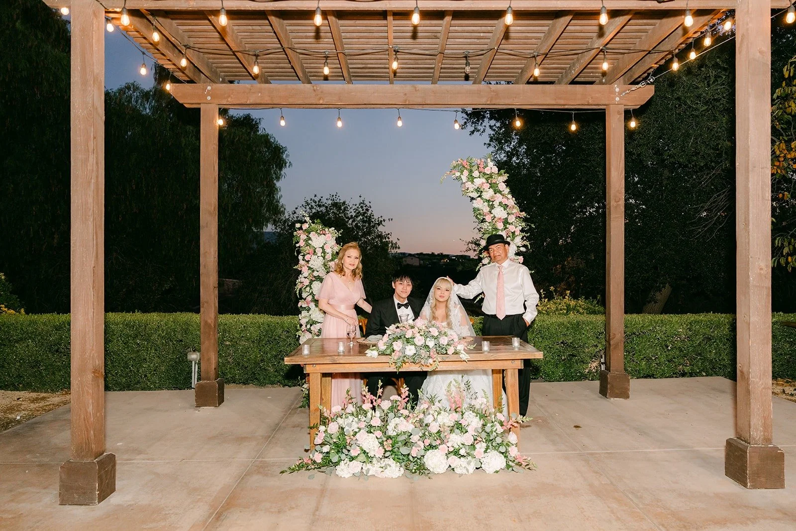 The sweetheart table under the wooden pergola at Bel Vino Winery