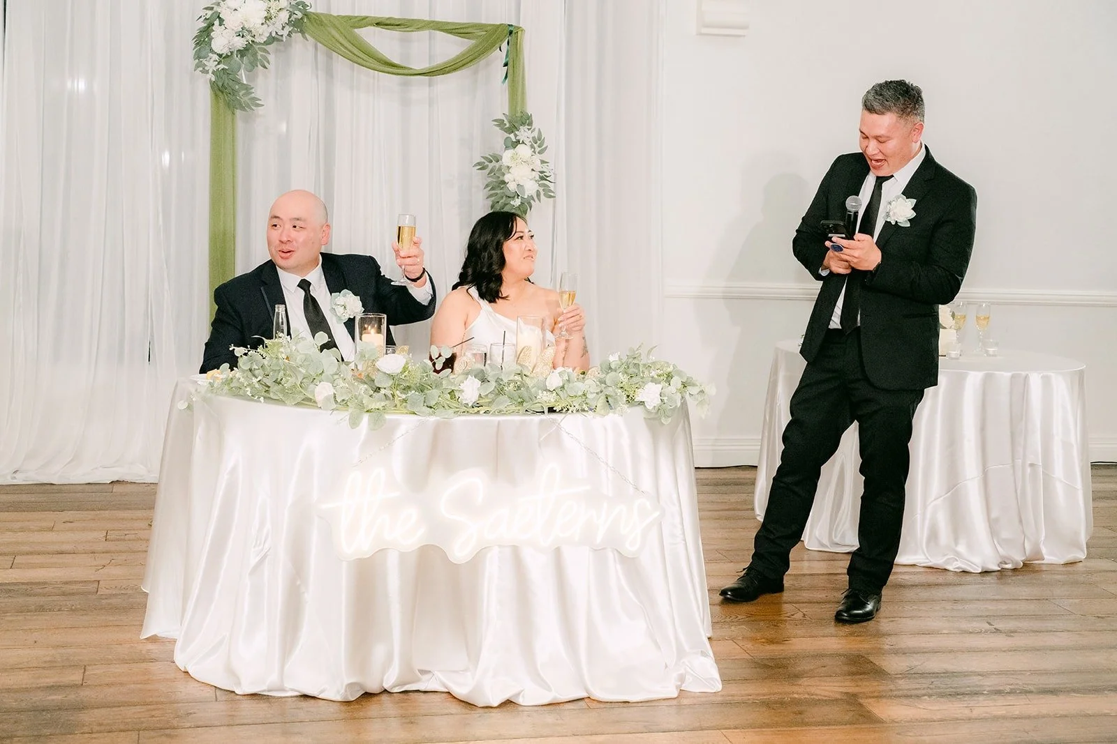 A groomsman toasting Vivian and Yao