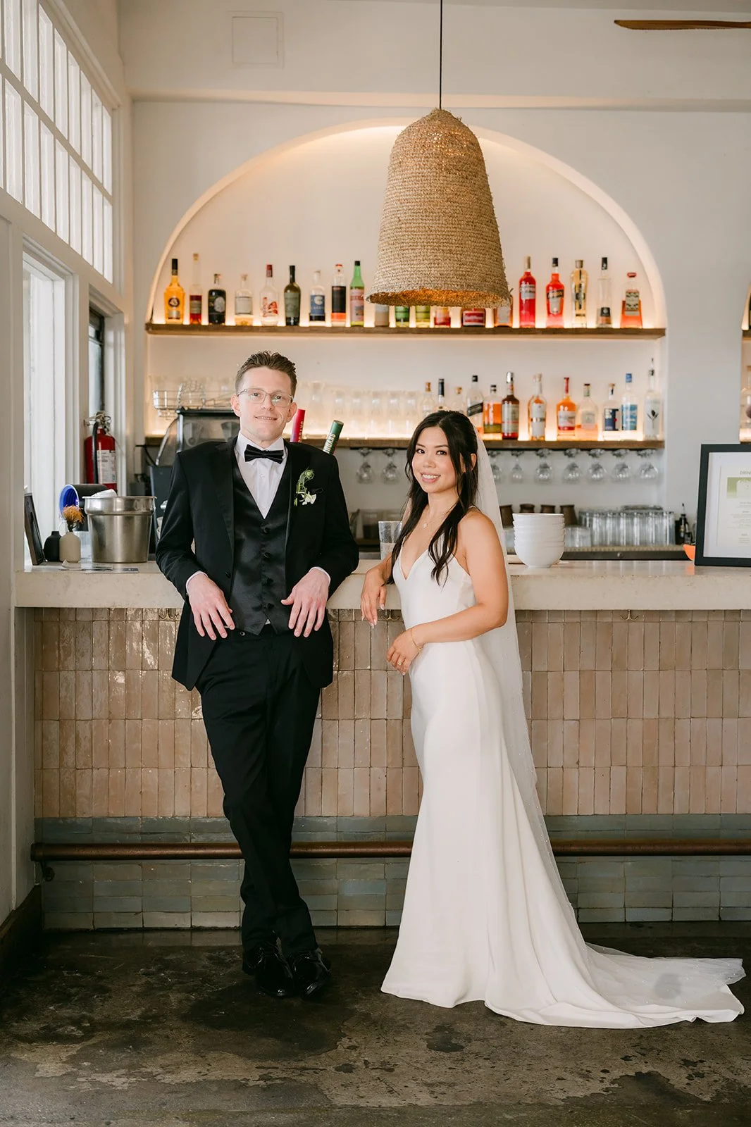 Justine and Matthew leaning on the bar