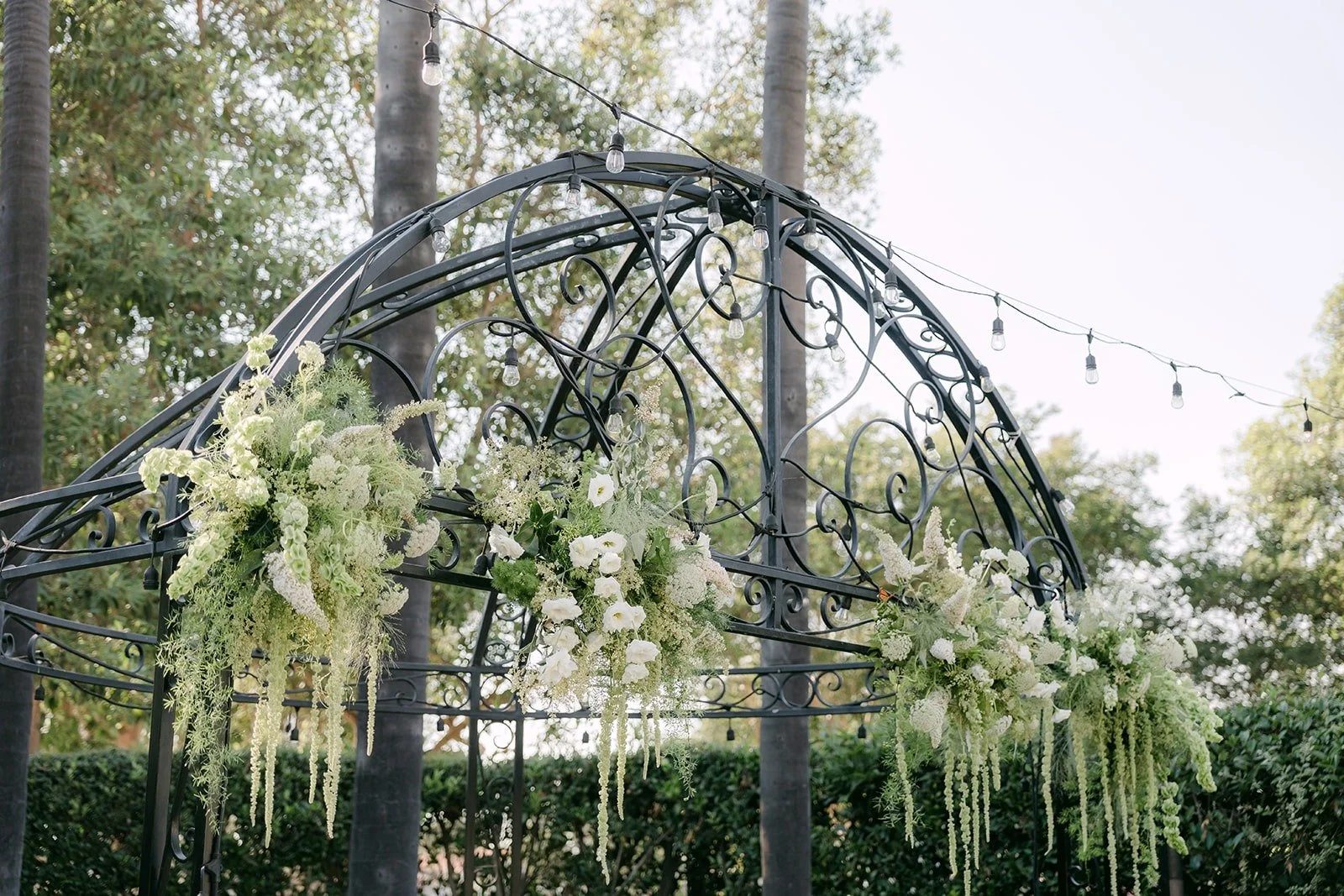 The iron arbor in the Italian Garden draped with florals