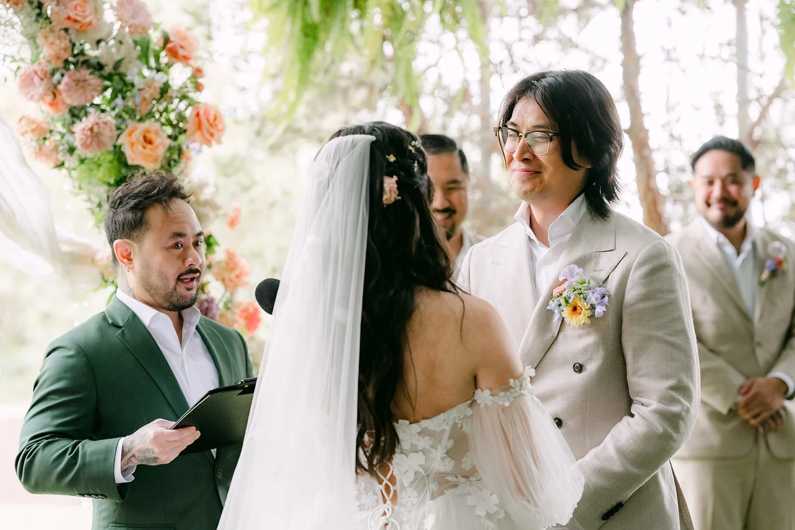 Officiant laughing with the couple during the ceremony