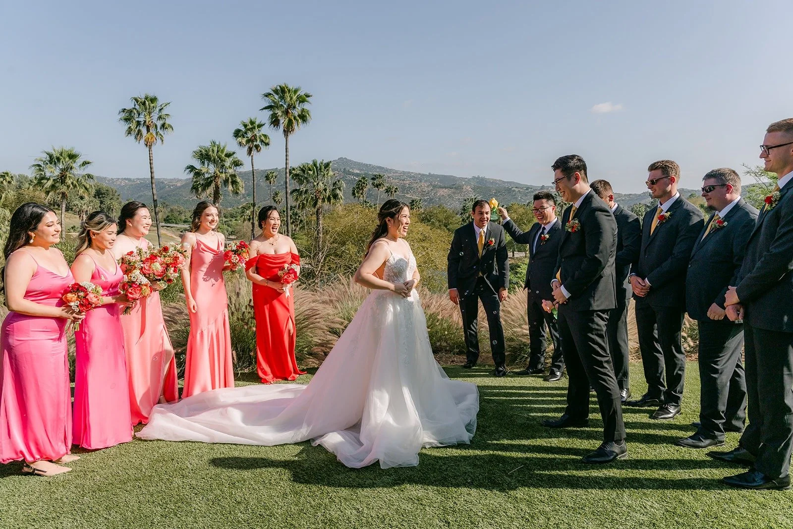 Joanne and Zach with their wedding party lined up on the lawn at Kijamii Overlook, photographed by One and Only Production