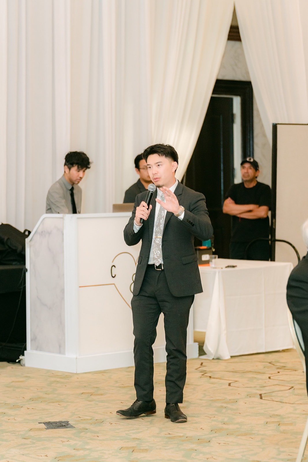 The emcee from 949 Studio welcoming guests to the San Gabriel Ballroom