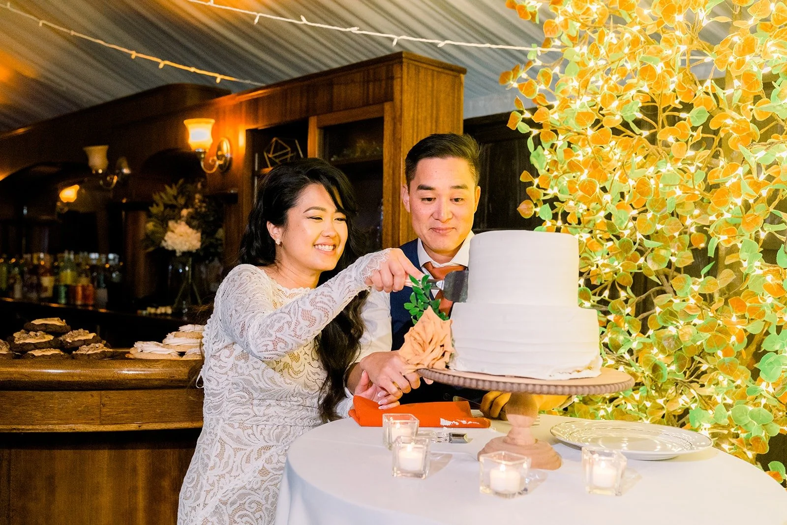 Hannah and Vincent sharing cake, photographed by One and Only Production