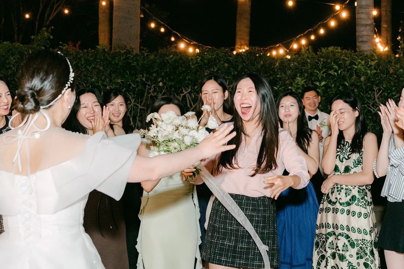 A guest catching the bouquet