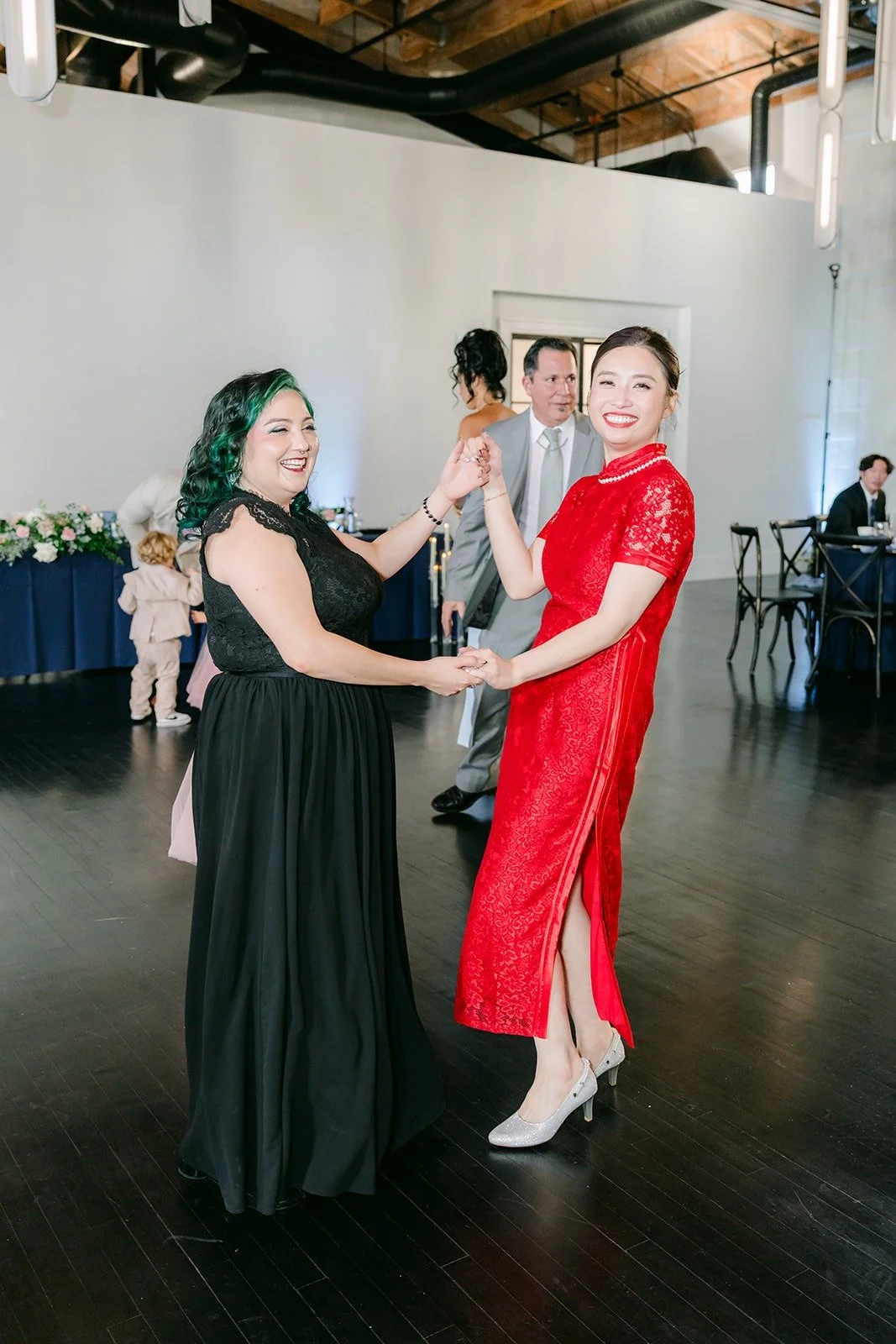 Elisa dances with a guest on the dance floor