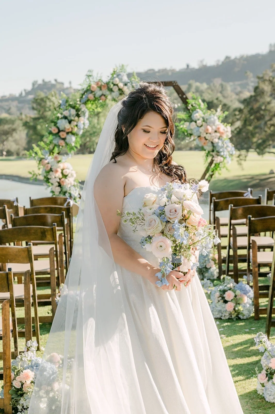 Florence in front of the hexagon ceremony arch on the 15th hole, photographed by One and Only Production