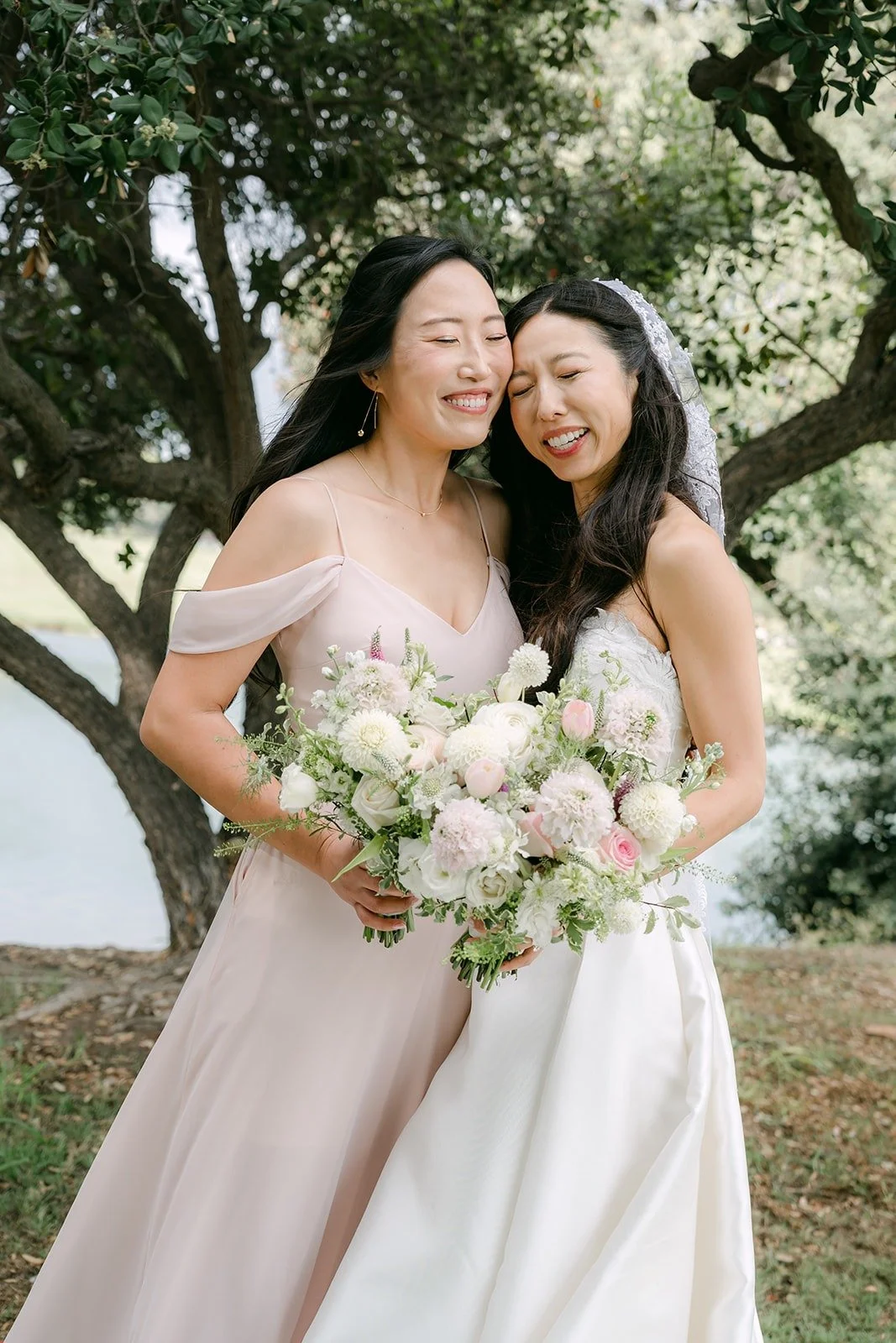 Kristine sharing a hug with a bridesmaid