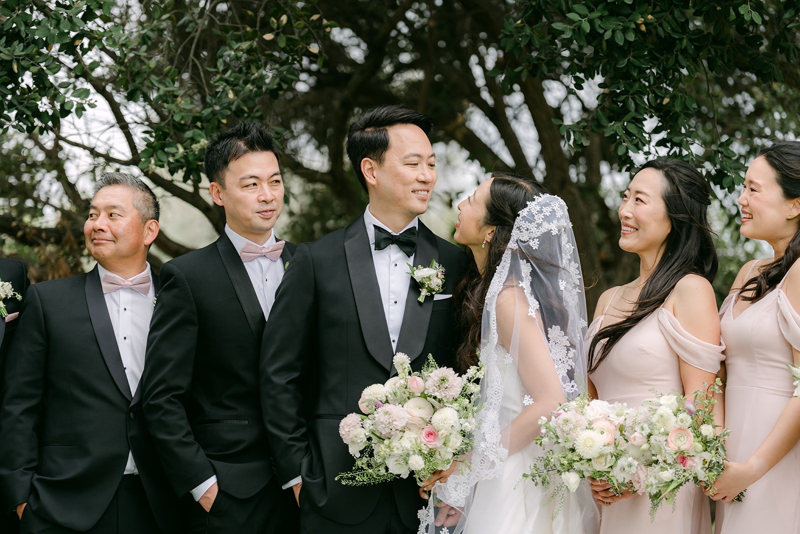Kristine and William with their wedding party under the trees