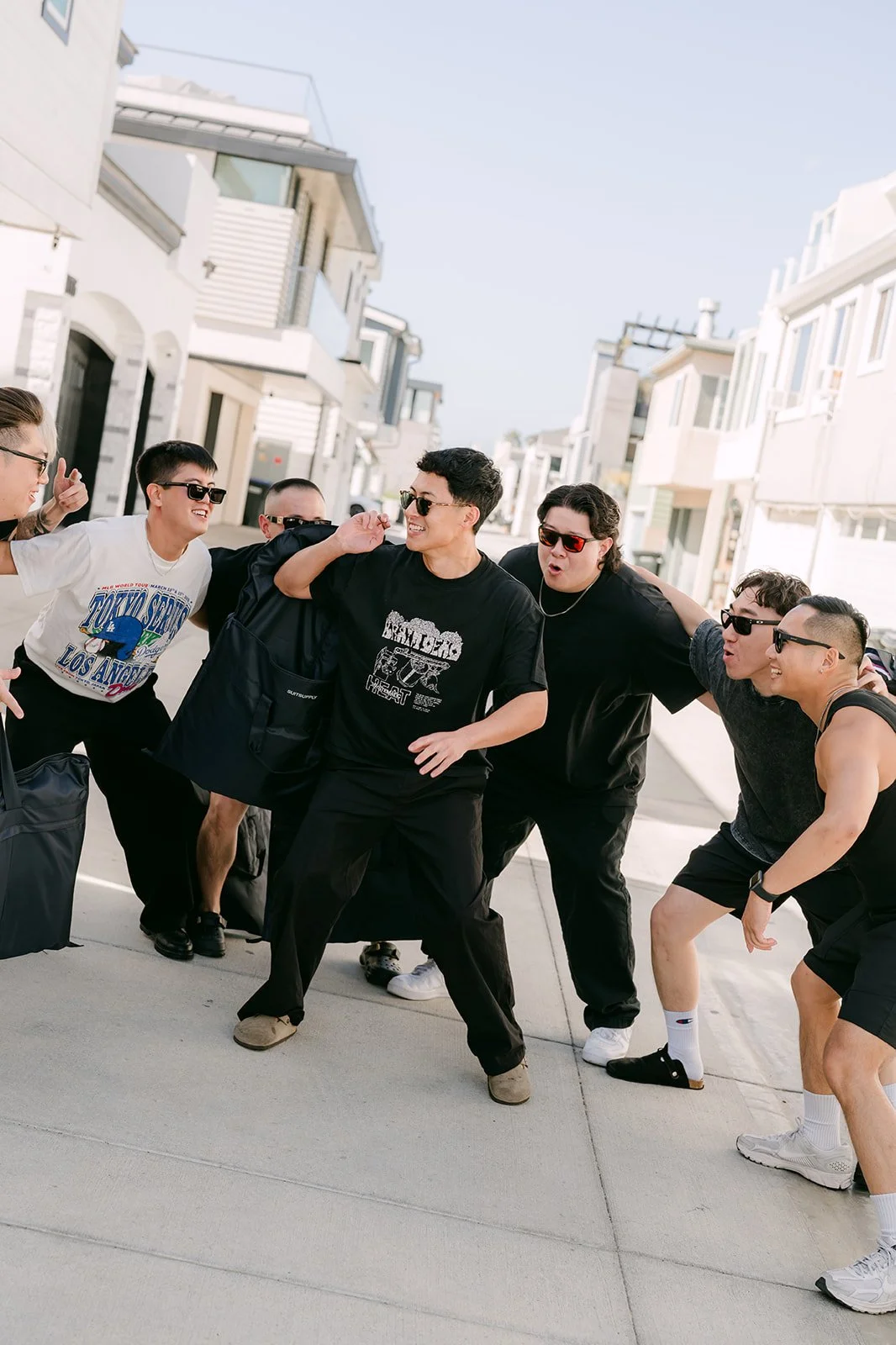 Groomsmen goofing around on the street on game day