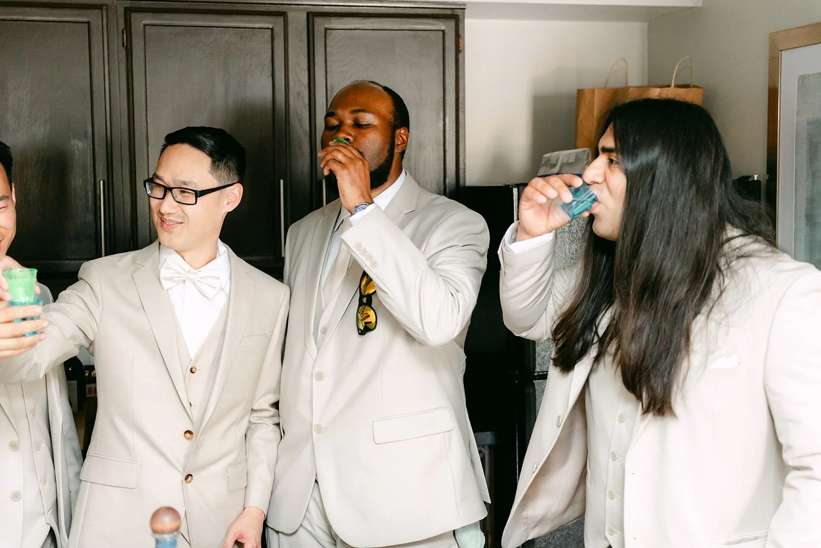 Kevin and his groomsmen in champagne suits getting ready.