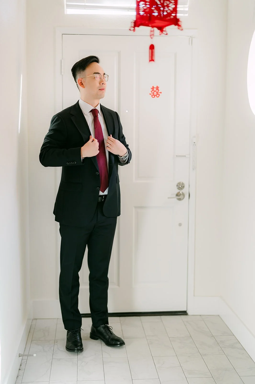 Ken waiting by the door, photographed by One and Only Production.