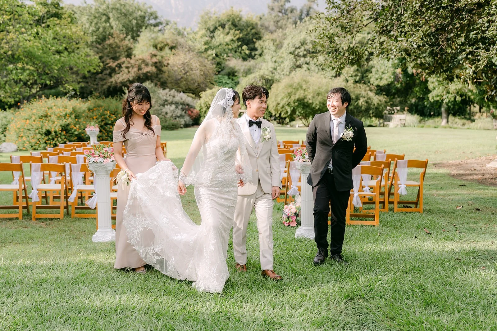 The wedding party walking across the lawn.