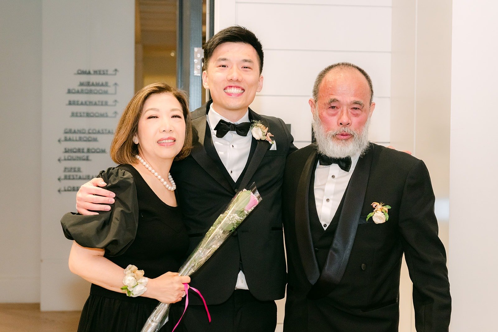 Eli standing with two family members during the speeches