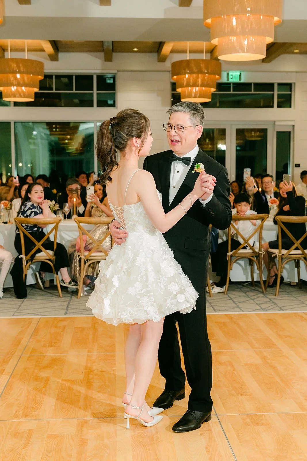 Angela smiling during a parent dance in the ballroom