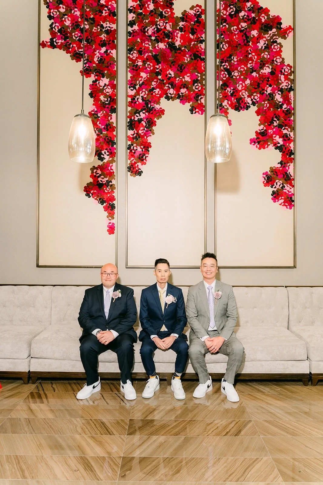 Bobby and the guys in front of the red floral wall, photographed by One and Only Production.